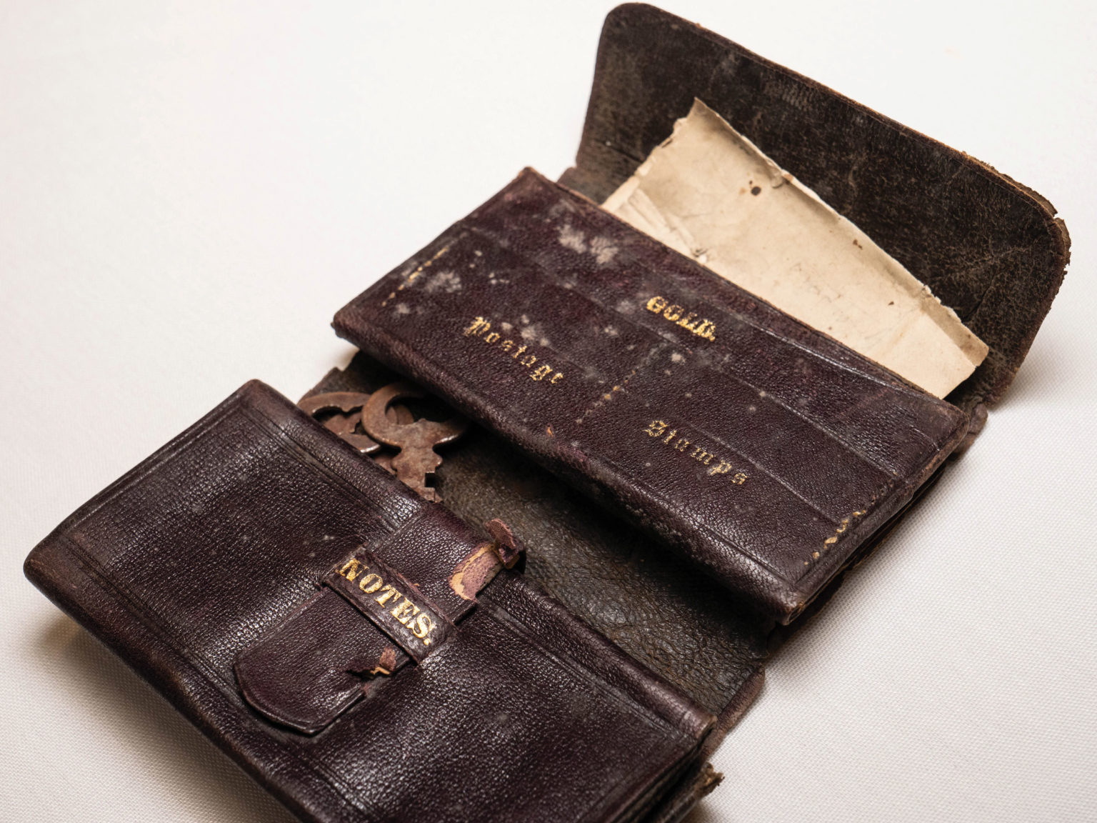 a 19th-century wallet with separate compartments for gold coins, postage stamps and the owner’s spectacles