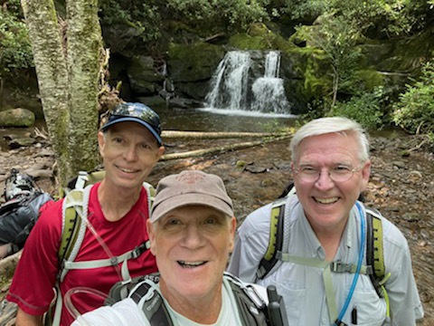 Hubbs, Maynard, and Morris pose in front of waterfall