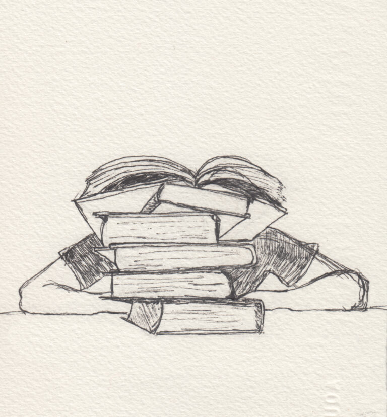 student hidden behind a stack of books