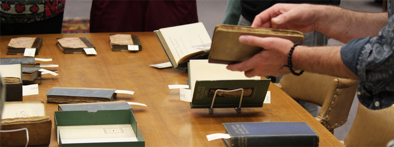 A student examines rare books in Special Collections.