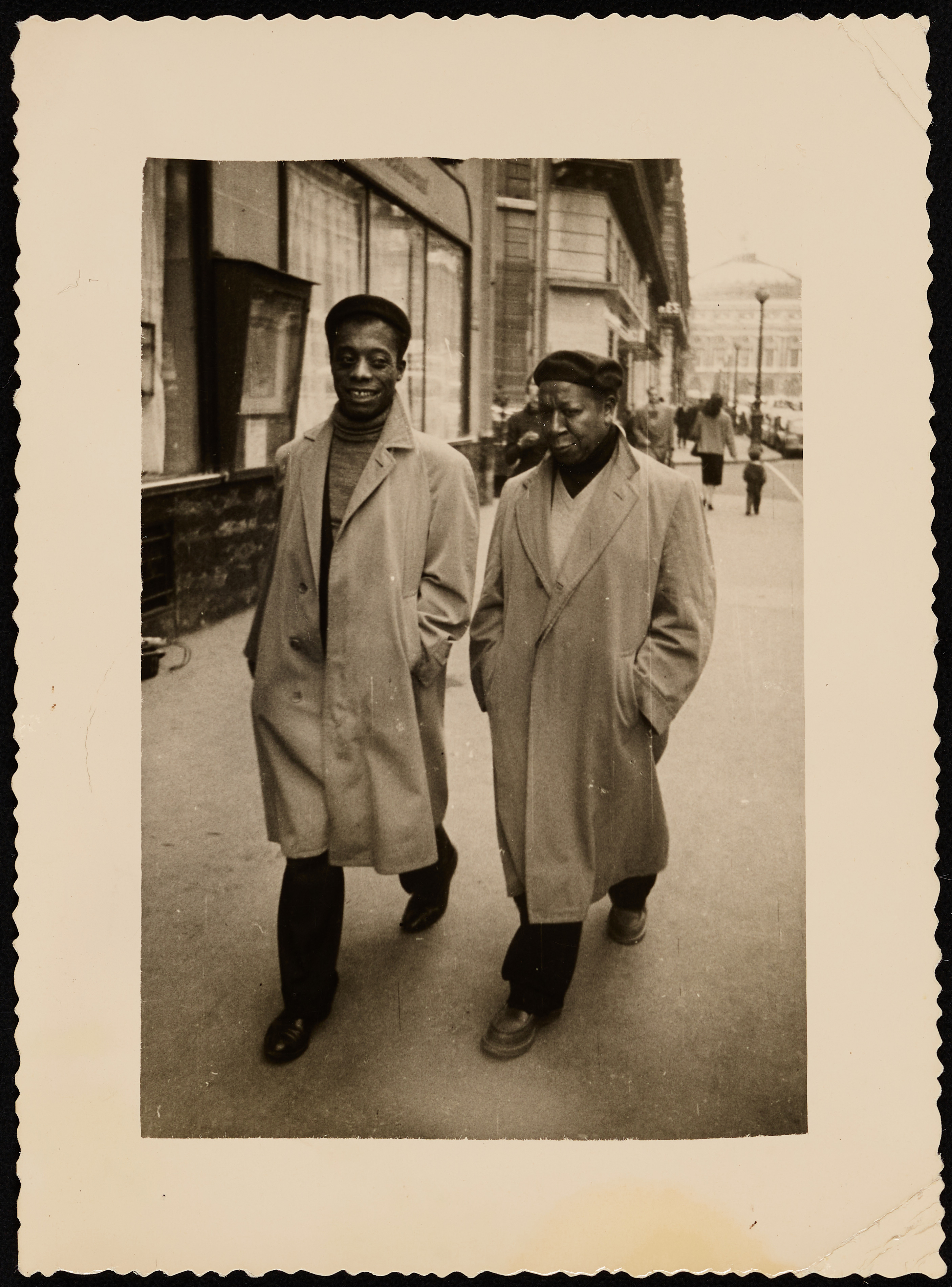 Photograph of James Baldwin and Beauford Delaney walking down a city street, circa 1950s.