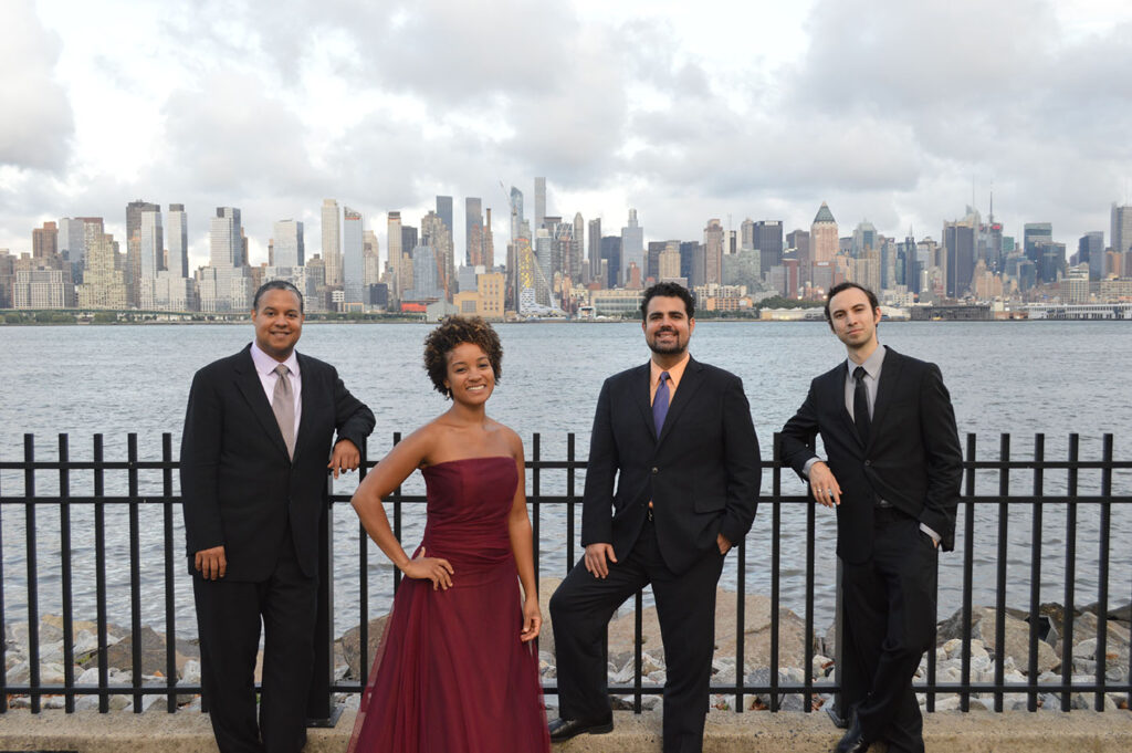The Harlem Quartet pose against the New York City skyline