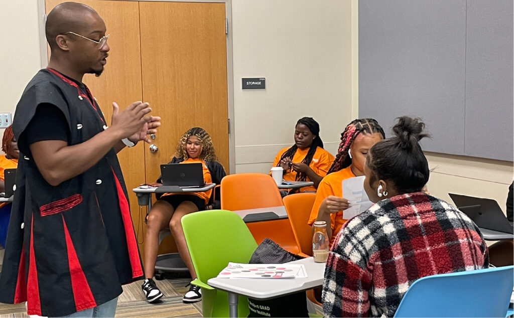 Project GRAD instructor Corey Hodge works with visiting high school students.