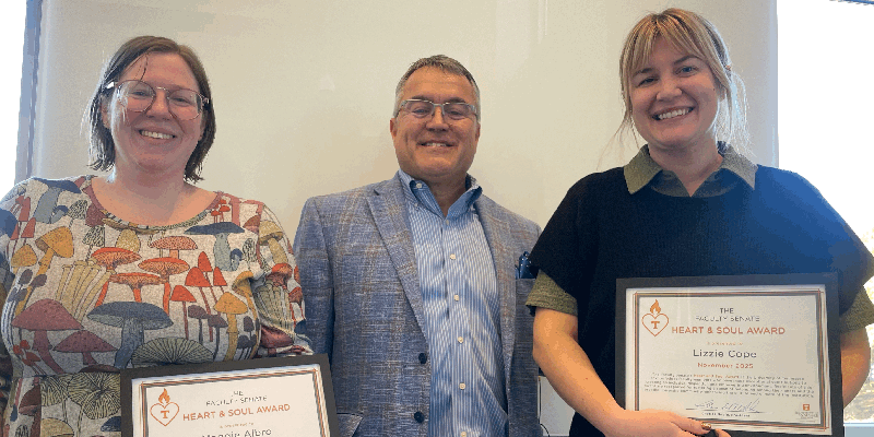 Faculty Senate president Charles Noble (center) presents the Senate’s Heart and Soul Awards to two librarians, Maggie Albro (left) and Lizzie Cope (right).