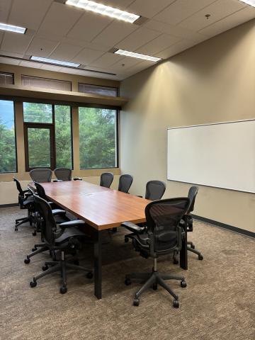 several tables and chairs in a large conference room