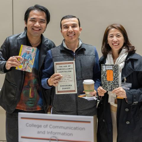 Three faculty honorees display their chosen titles at the 2025 Faculty Bookplate Reception.