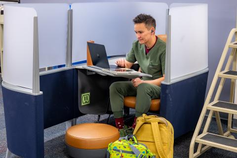 Photograph of student sitting in a study pod at the Pendergrass Quiet Study Zone