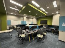 photo of chairs, tables, and computers in the gaming lab