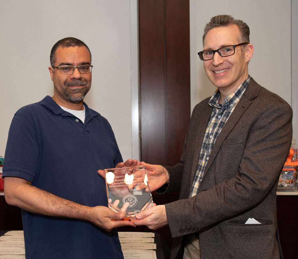 Bryan Davis receives the Extraordinary Customer Service Award from Paul James.