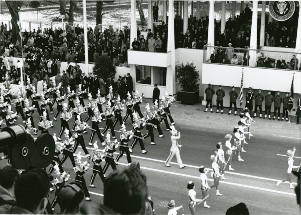 Pride of the Southland band marches past the inaugural platform